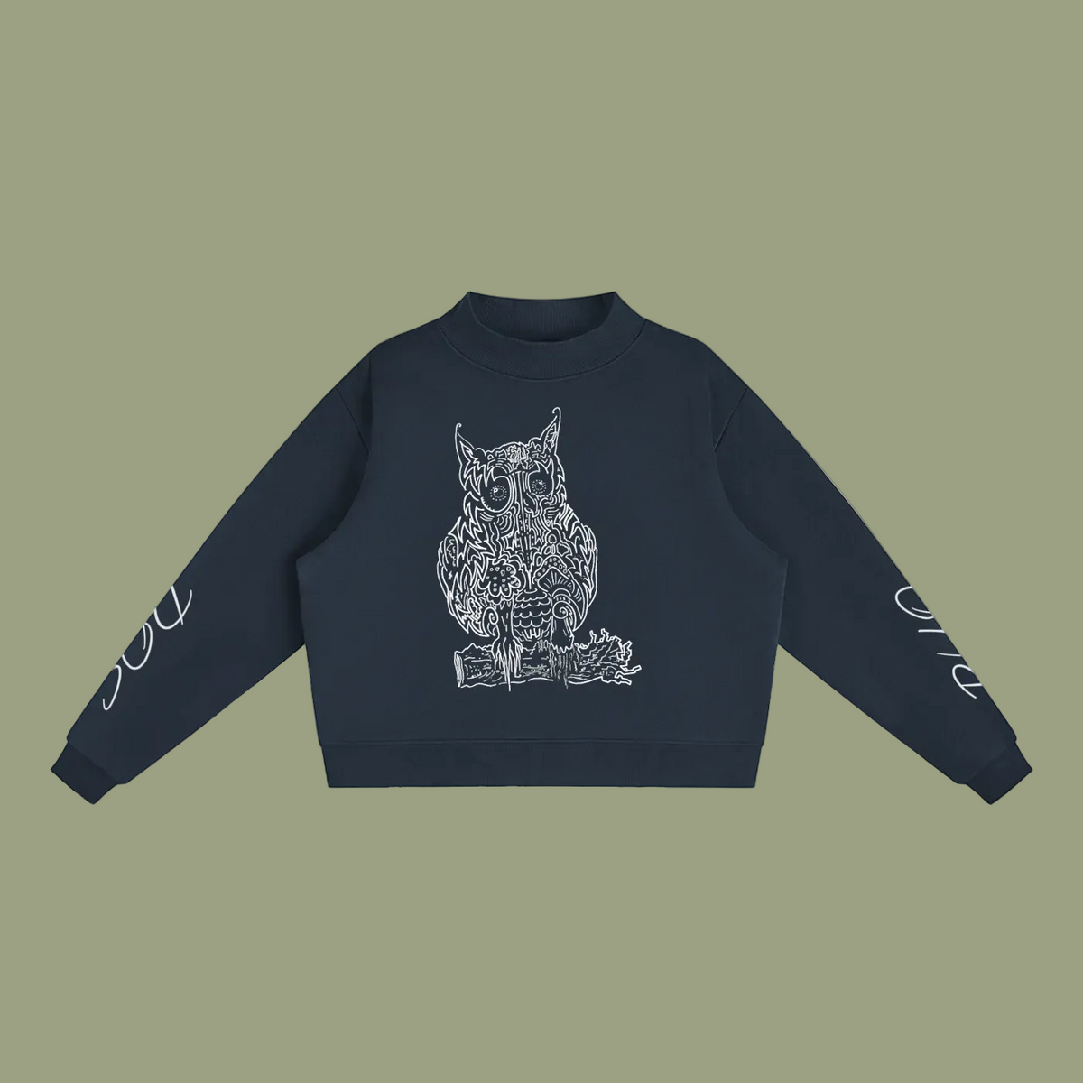 A navy blue cropped sweatshirt featuring a white line art graphic of an owl on the chest, with white script text printed on both sleeves, displayed against a solid white background.