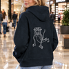 A maroon hoodie shown from the back, featuring a white line art graphic of a cartoon monkey on the center back, set against a plain white background.